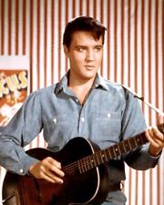 Elvis Presley picks at his guitar in denim shirt from 1964 Roustabout Poster picture