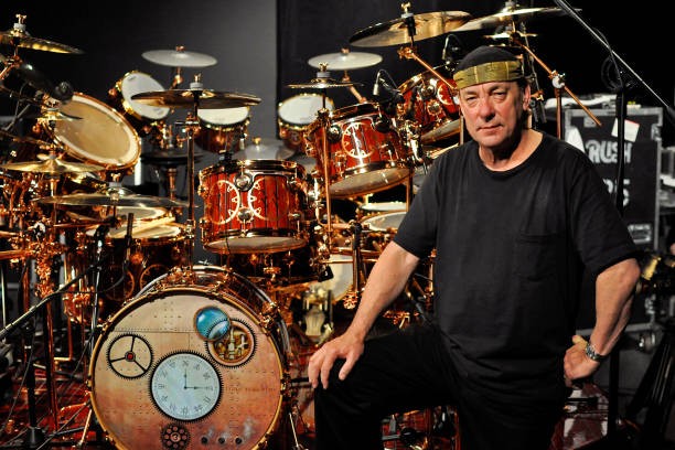Neil Peart of Rush poses for a portrait with his DW drum kit the D- Old Photo